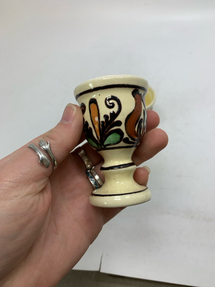 VTG 2 SMALL FOOTED YELLOW EGG CUPS W/ BROWN DETAIL.