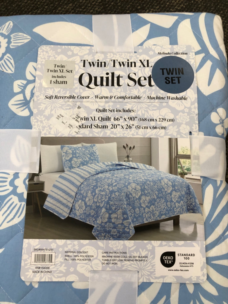 NIP REVERSIBLE BLUE FLORAL TWIN/ XL QUILT SET.