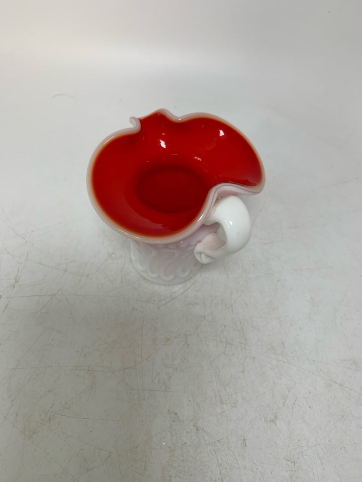 TEXTURED MILK GLASS W/ RED INTERIOR PINCHED SPOUT CREAMER.
