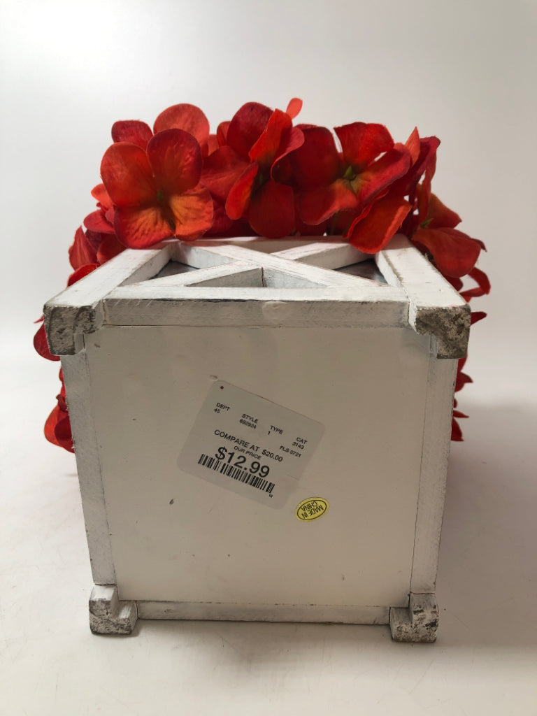 RED FLORALS IN "X" FRAME PLANTER.