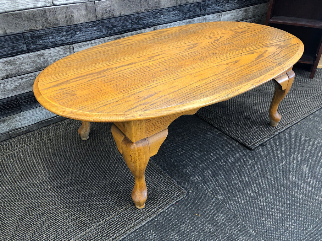 OAK WOOD OVAL COFFEE TABLE .