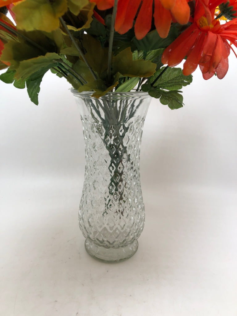 ORANGE FLORALS IN TEXTURED GLASS VASE.