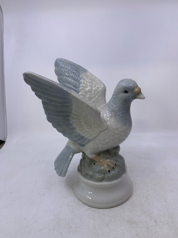 CERAMIC PIGEON ON ROCKS.