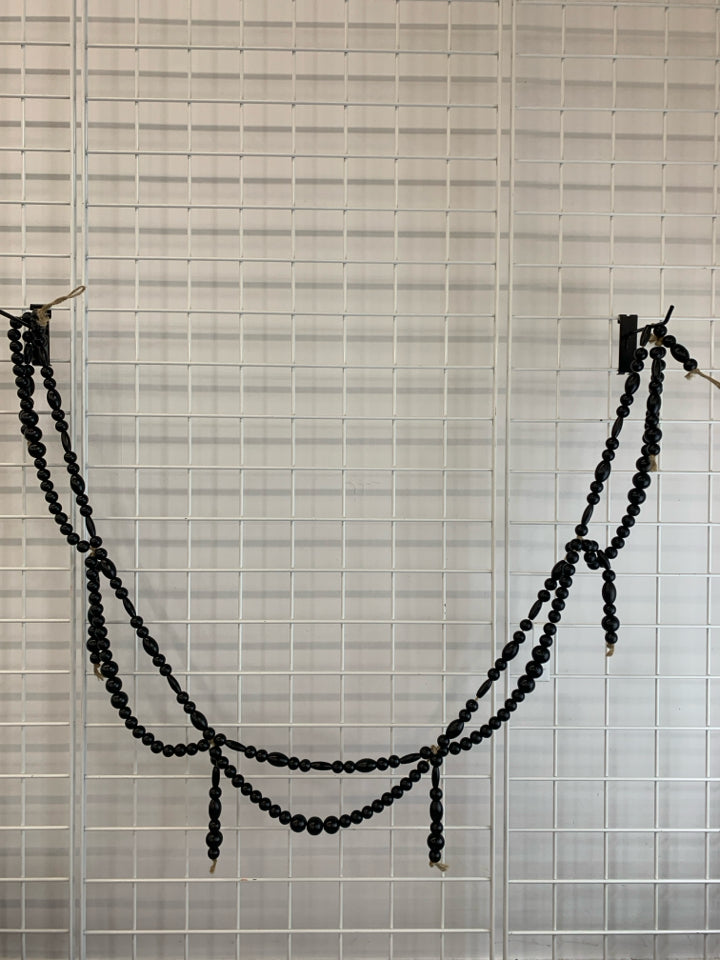 BLACK WOODEN BEADED GARLAND.