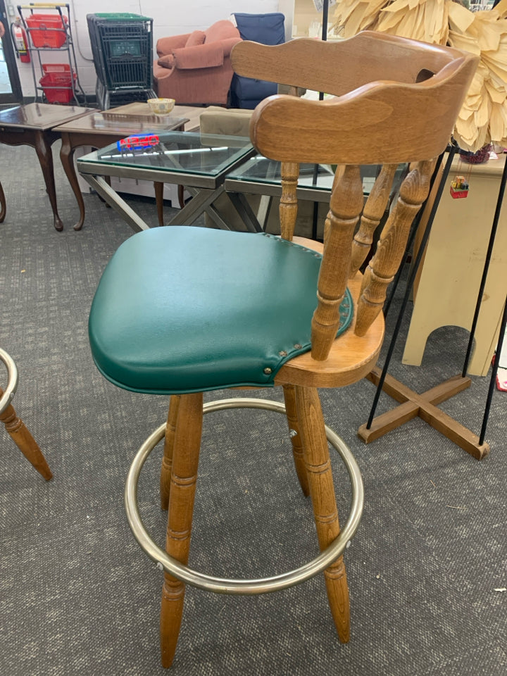 2 WOOD BAR STOOL W/GREEN UPHOLSTERED CUSHION & METAL FOOT REST.