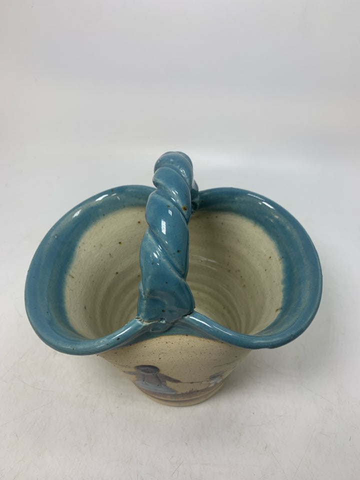 BASKET VASE W/ MOTHER/SON HOLDING HANDS LOOKING OUT LIGHT BLUE EDGES.