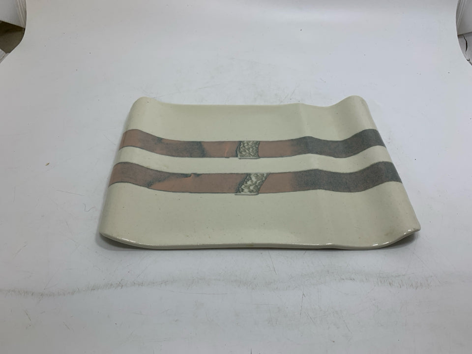 CREAM UNEVEN POTTERY TRAY W/ PINK GRAY STRIPES.
