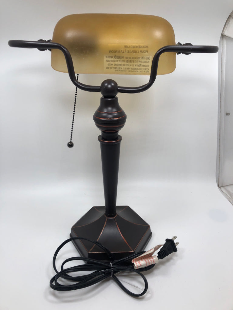 BRONZE BANKERS LAMP W/AMBER GLASS SHADE.