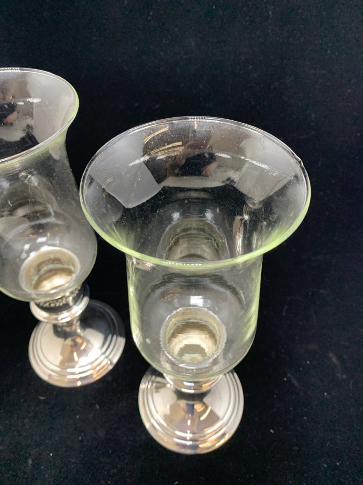 2 GLASS CANDLE HOLDERS W/SILVER BASE.