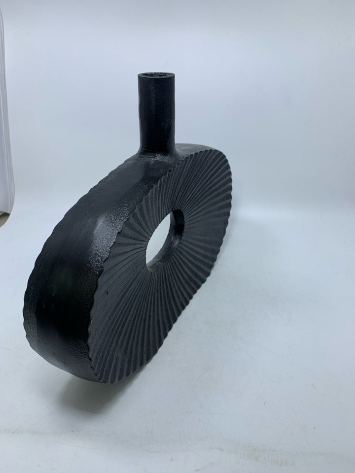 LARGE BLACK RIBBED METAL DONUT HOLE VASE.