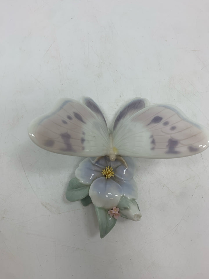 PORCELAIN BUTTERFLY ON FLOWER FIGURINE.