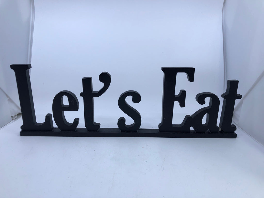 BLACK LETS EAT SIGN.