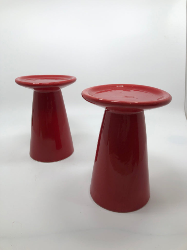 2 RED CERAMIC CANDLE HOLDERS.