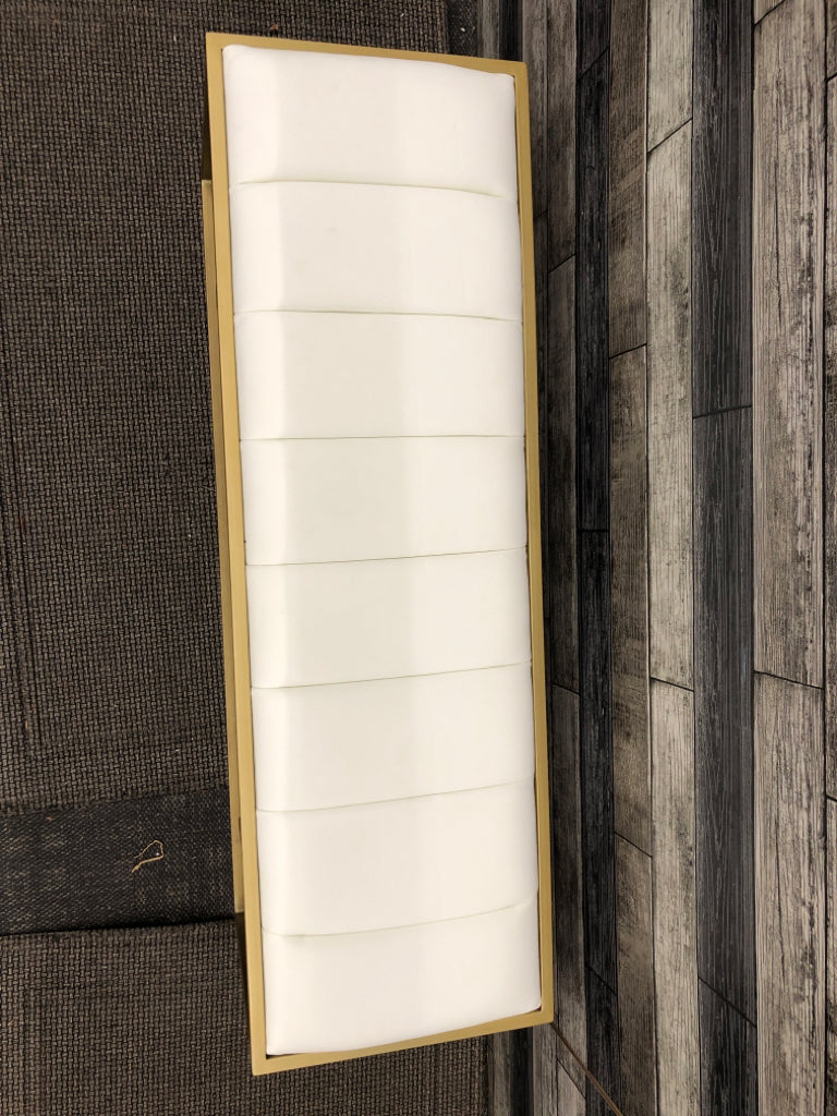UPHOLSTERED WHITE FAUX-LEATHER BENCH W/GOLD FRAME.