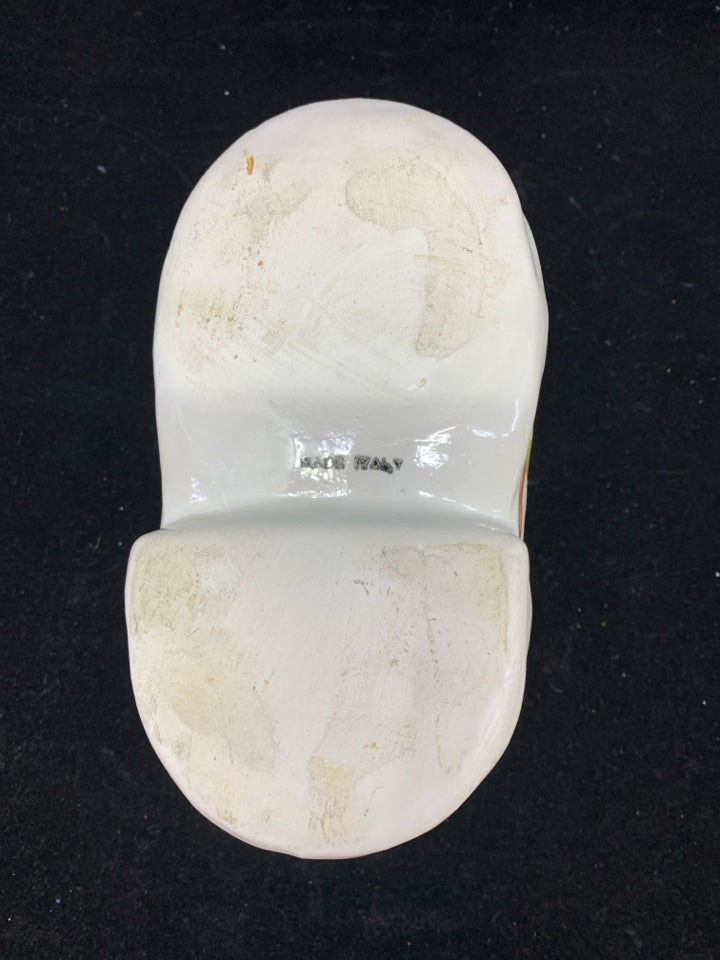 WHITE CERAMIC BOOT PLANTER W/PINK FLOWERS.