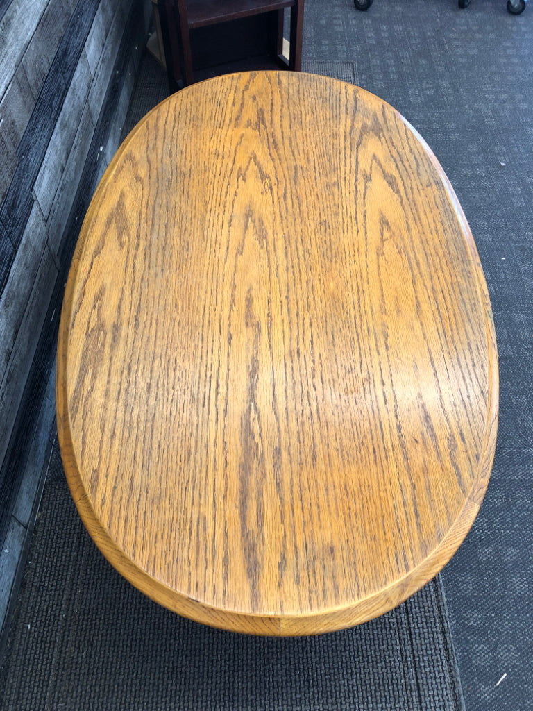 OAK WOOD OVAL COFFEE TABLE .