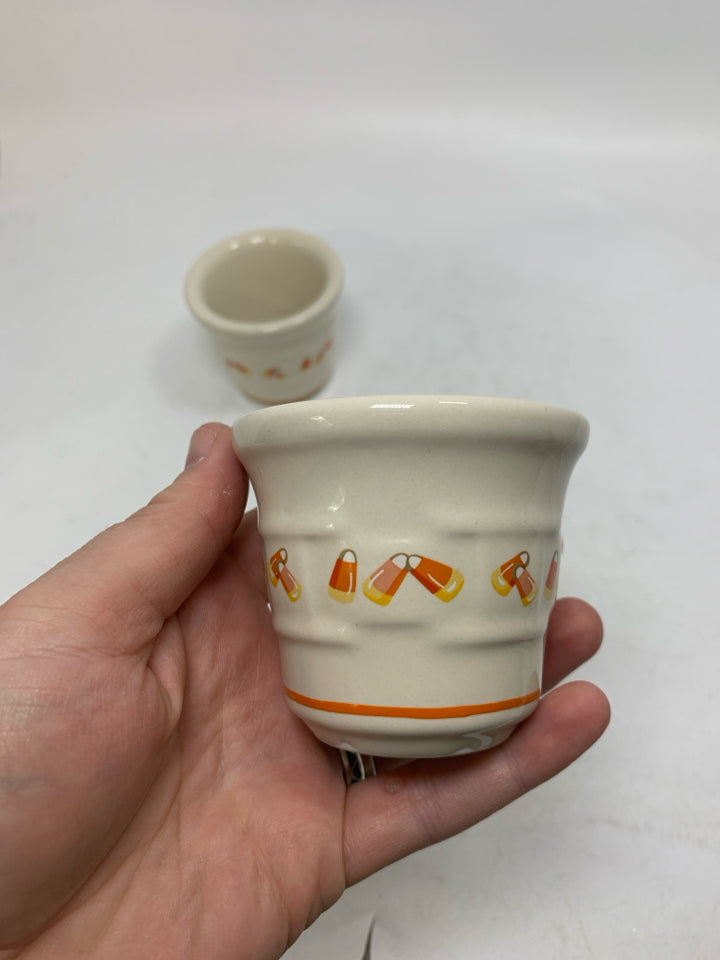 2 CANDY CORN VOTIVES POTTERY HOLDERS.