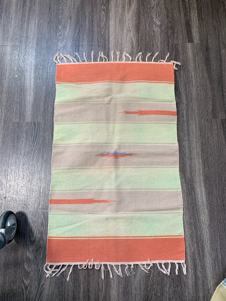 ASSORTED COLORS WOVEN AZTEC PATTERN RUG W/ TASSELS.