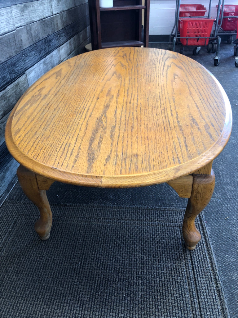 OAK WOOD OVAL COFFEE TABLE .