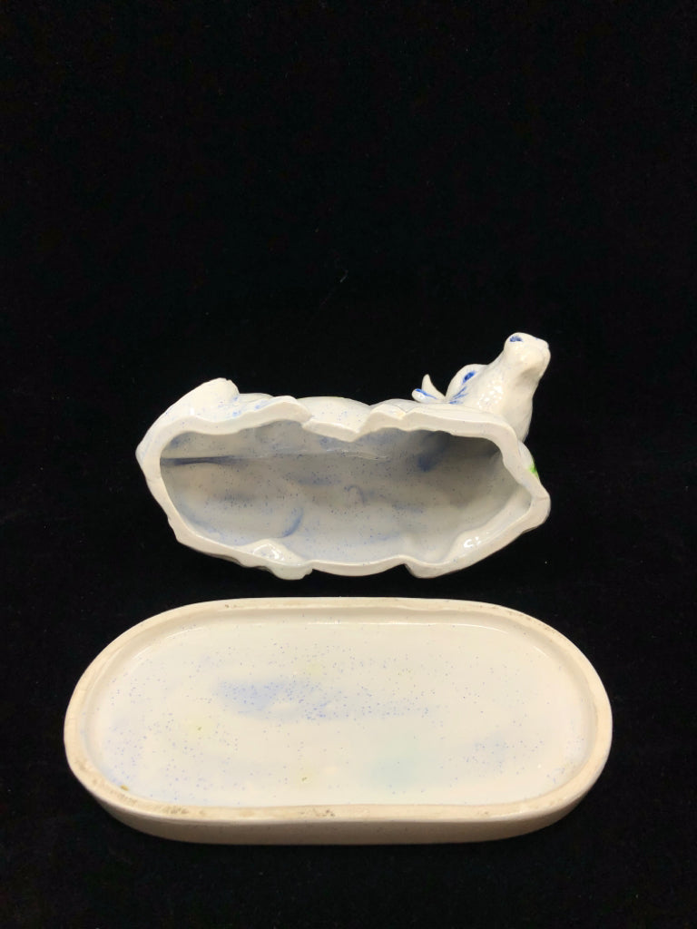 CERAMIC COW COVERED BUTTER DISH W/BLUE & YELLOW FLORAL MOTIFS.