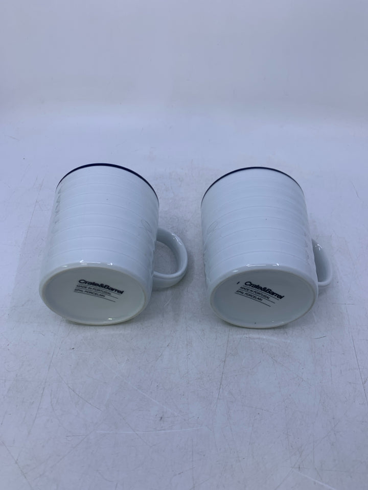 2 WHITE RIBBED MUGS W/ BLUE RIM.