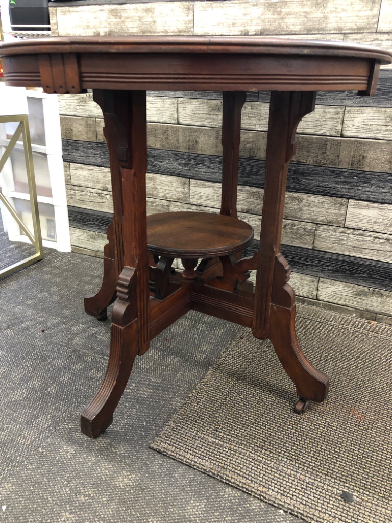 VTG DARK WOOD ROUND END TABLE ON WHEELS.