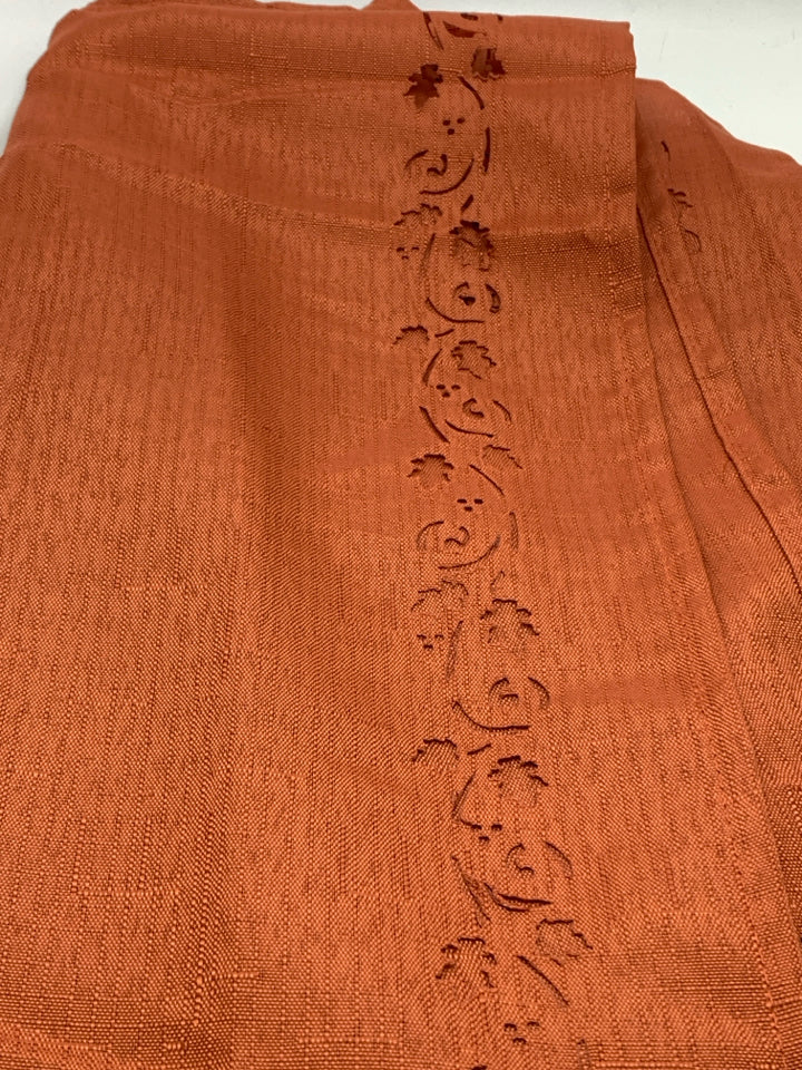 ORANGE TABLECLOTH W/LEAF CUT-OUTS.