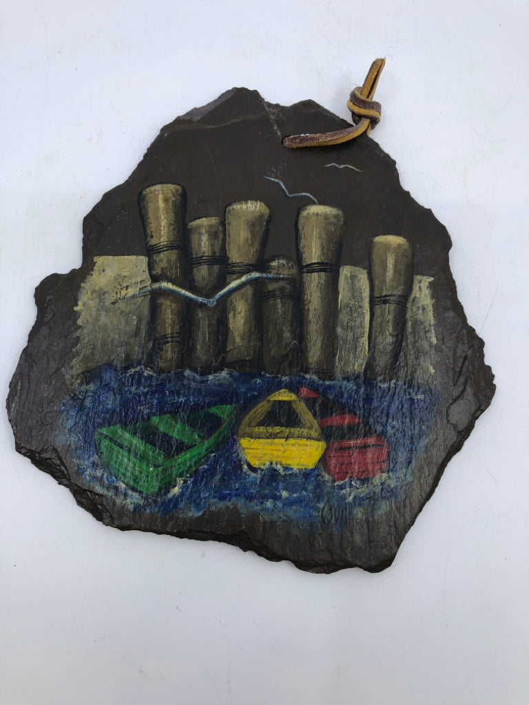 BROWN PAINTED SLATE W/ 3 COLORED BOATS WALL HANGING.