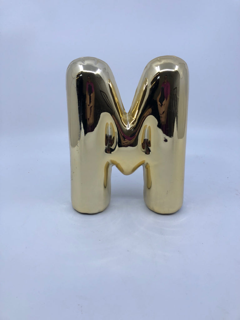GOLD "M".