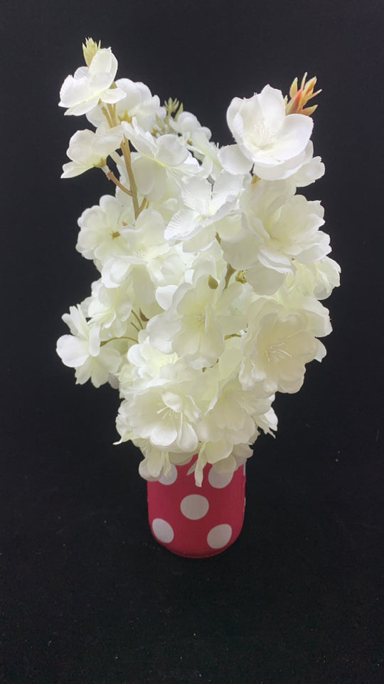 WHITE FAUX FLOWERS IN PINK POLKA DOT JAR.