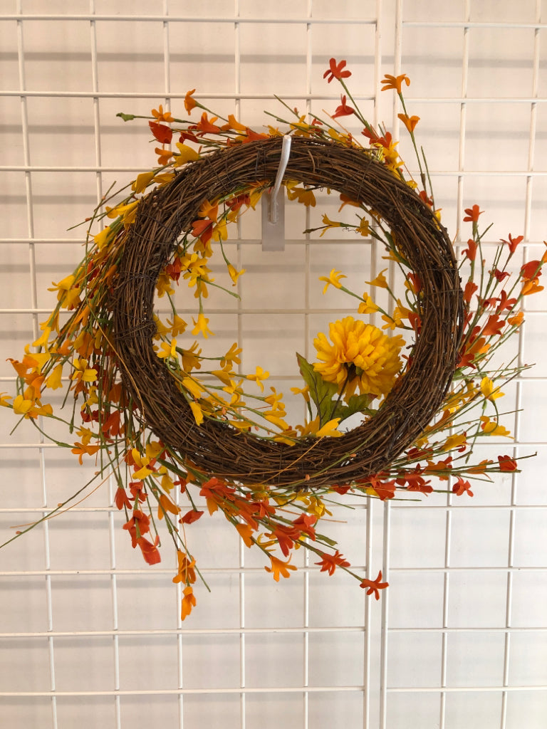 ORANGE/ YELLOW FLOWWRS STICK WREATH.