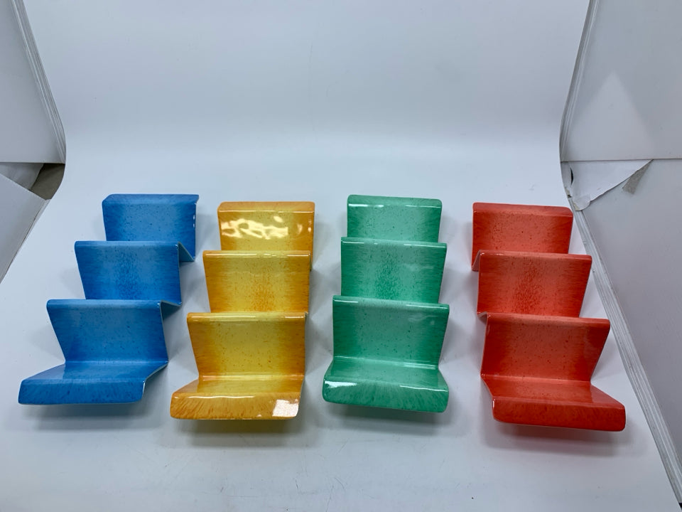 4 PLASTIC ASSORTED COLOR TACO HOLDERS.
