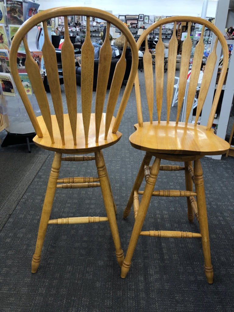 2 SWIVEL OAK BAR STOOLS.