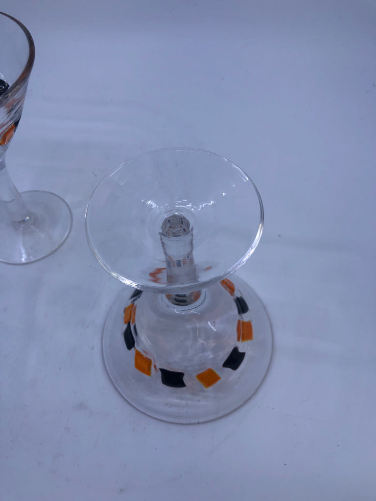 2 BLACK AND ORANGE MARTINI GLASSES.