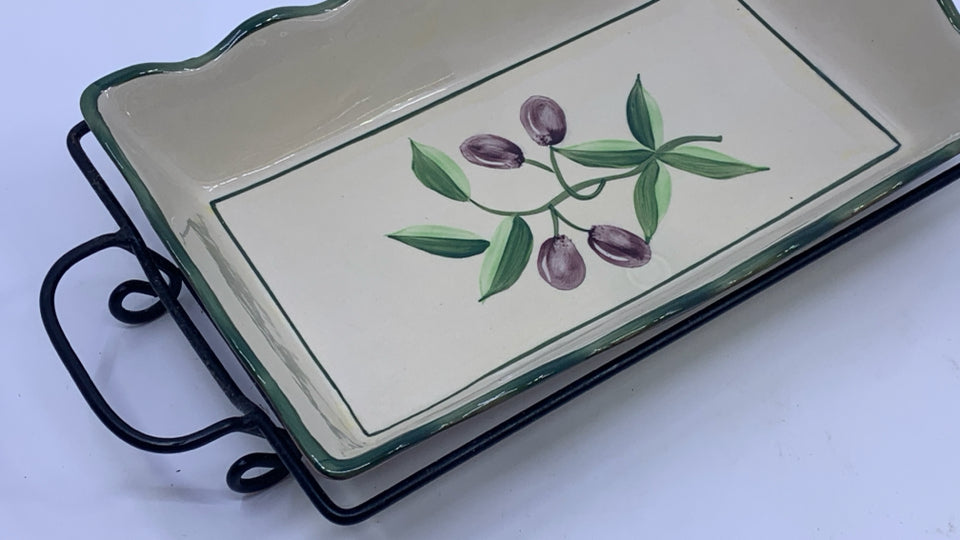 OLIVE CASSEROLE DISH IN METAL HOLDER.