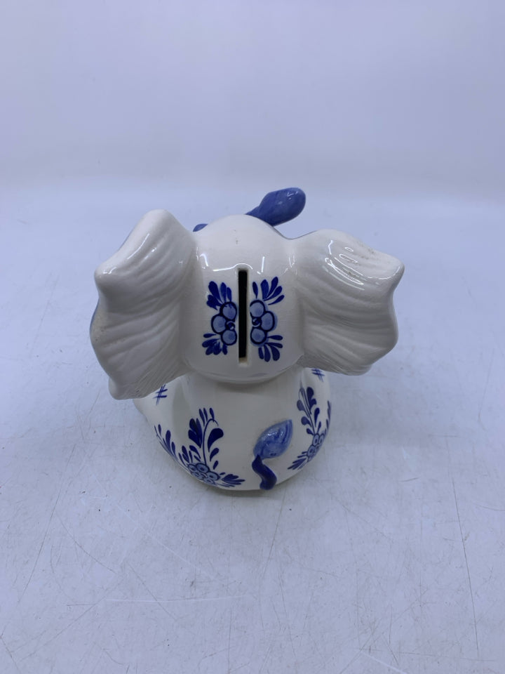 BLUE/WHITE SITTING ELEPHANT W/ BABY HANGING FROM TRUNK COIN BANK.