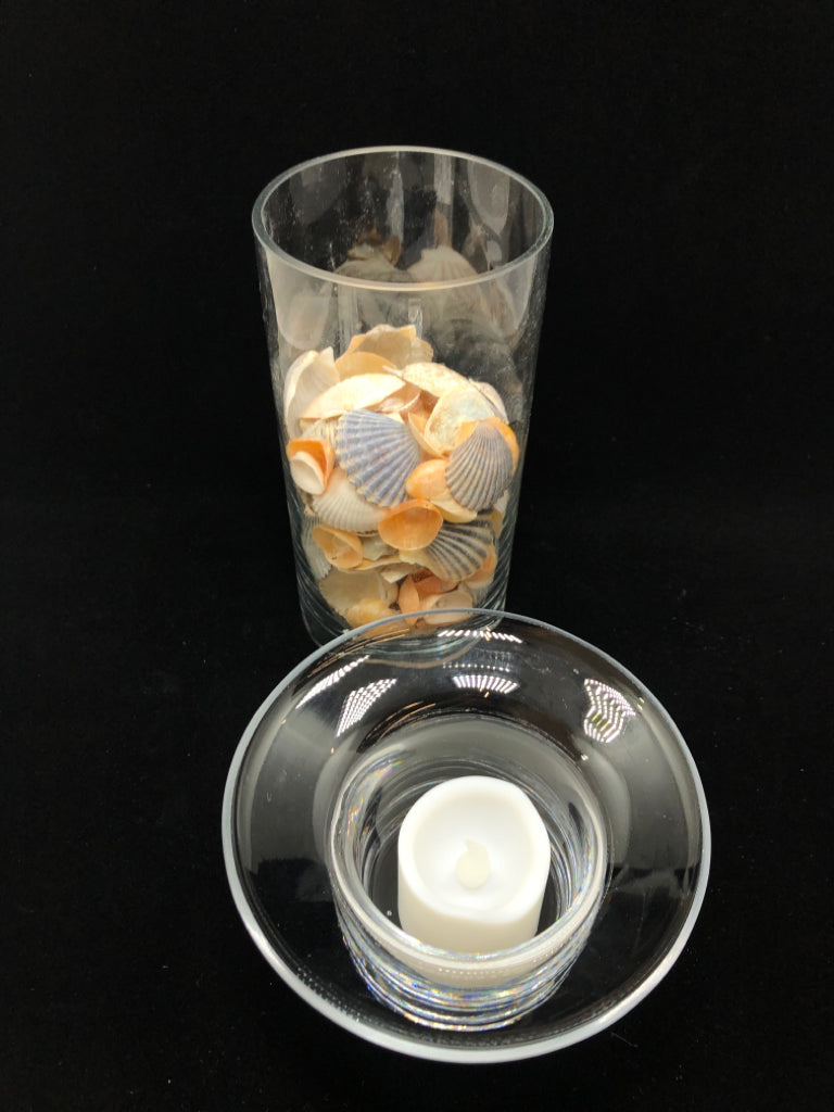 SEASHELL FILLED GLASS CANDLE HOLDER.