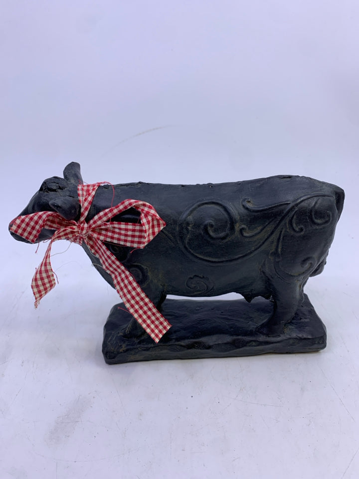 BLACK STANDING COW W/ SWIRL DESIGN.