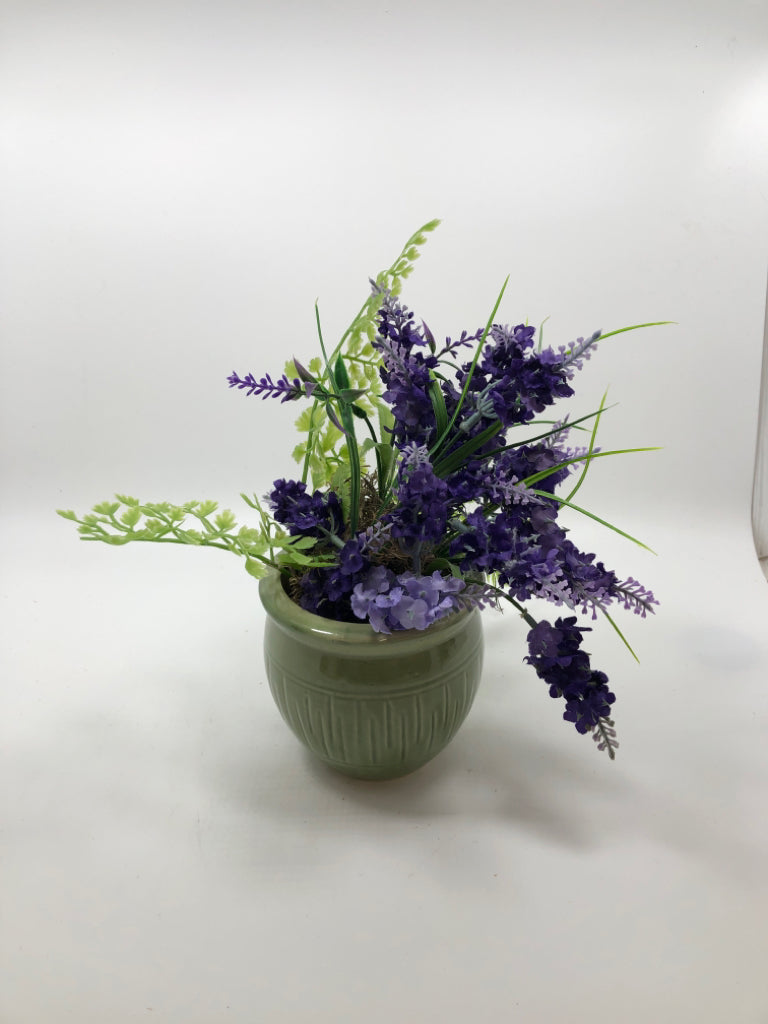 PURPLE FLOWERS IN GREEN POT.