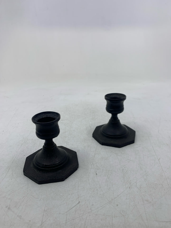2 BLACK METAL SHORT TAPERED CANDLE HOLDERS.