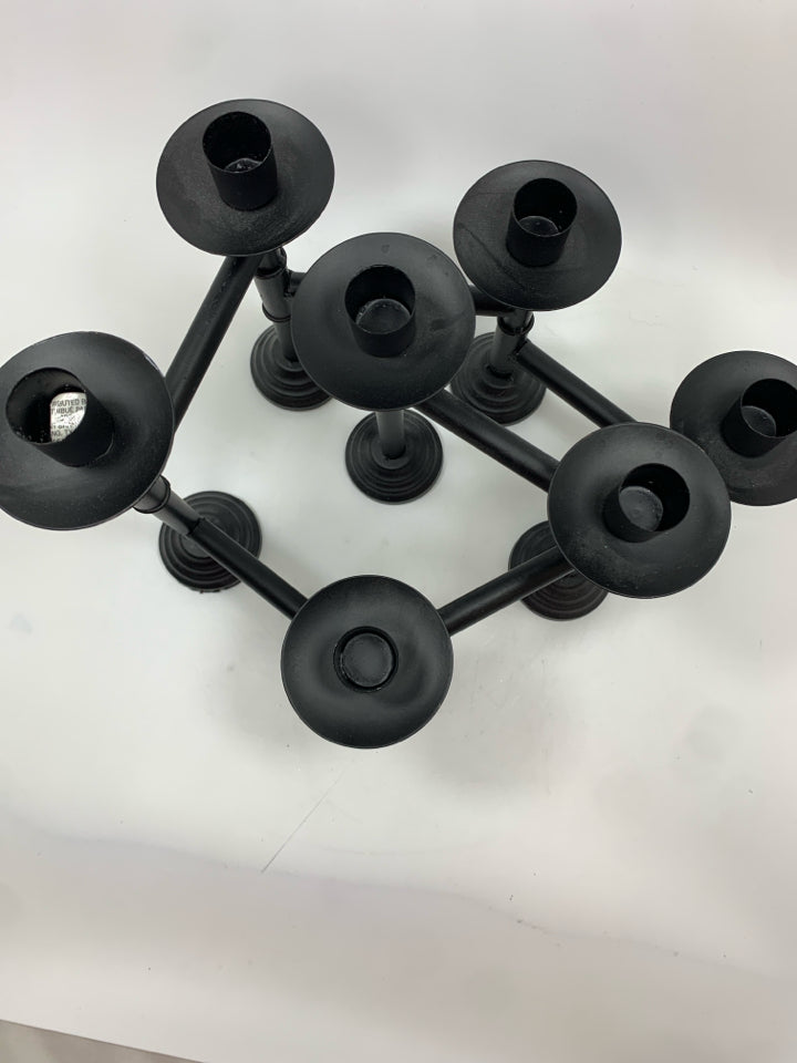 BLACK METAL ADJUSTABLE CANDLESTICK HOLDER.