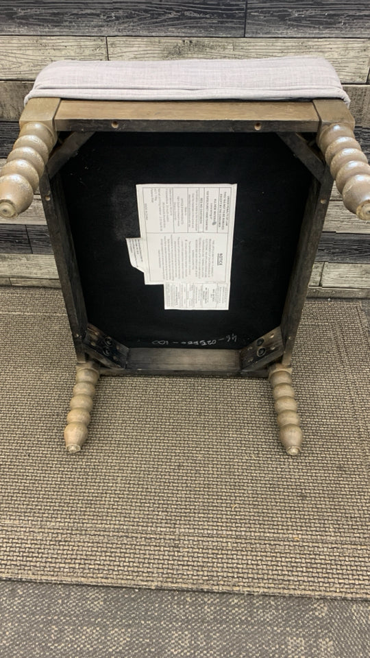 GREY OTTOMAN W/SPIRAL WOODEN LEGS.