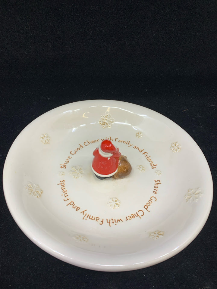 SHARE GOOD CHEER CREAM CERAMIC PLATE WITH RESIN SANTA & TOY BAG IN CENTER.