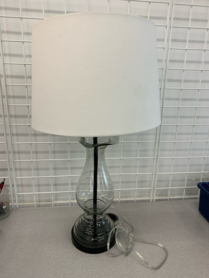 HOLLOW GLASS BASE W/ WHITE SHADE LAMP.