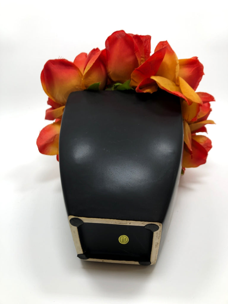 ORANGE FLOWERS IN BLACK POT.