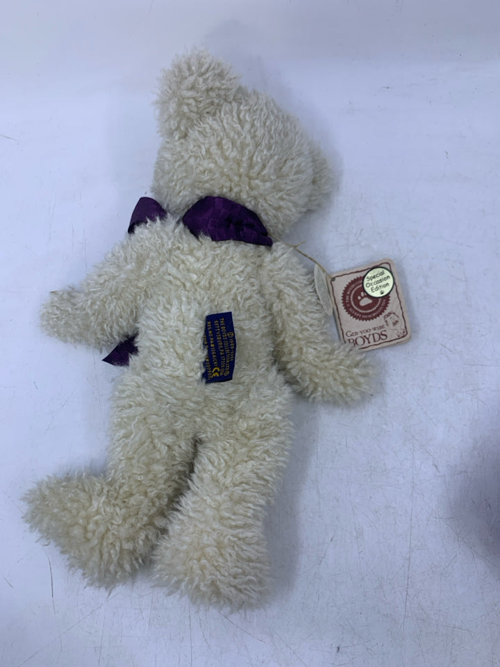 SCRUFFY WHITE BEAR W/ PURPLE BOW.