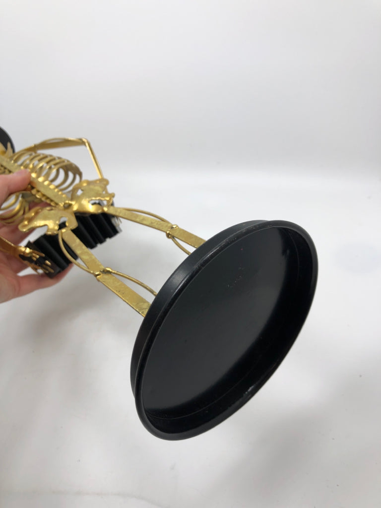 GOLD SKELETON SCULPTURE WITH TOP HAT AND ACCORDION.