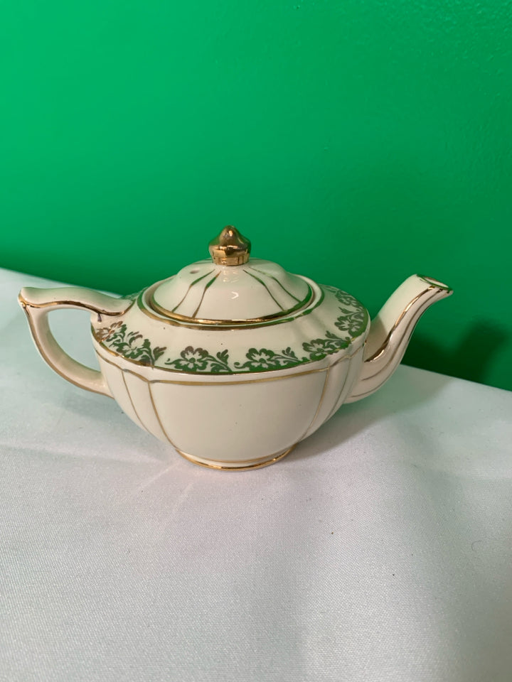 VTG CREAM AND GOLD TEAPOT.