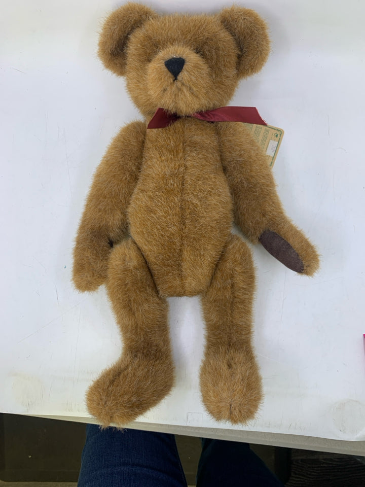 CARMEL COLORED BEAR W/ RED RIBBON.