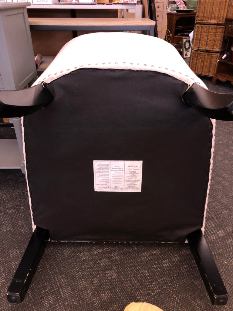 WHITE ACCENT CHAIR STUDDED BOTTOM W/ BLACK LEGS.